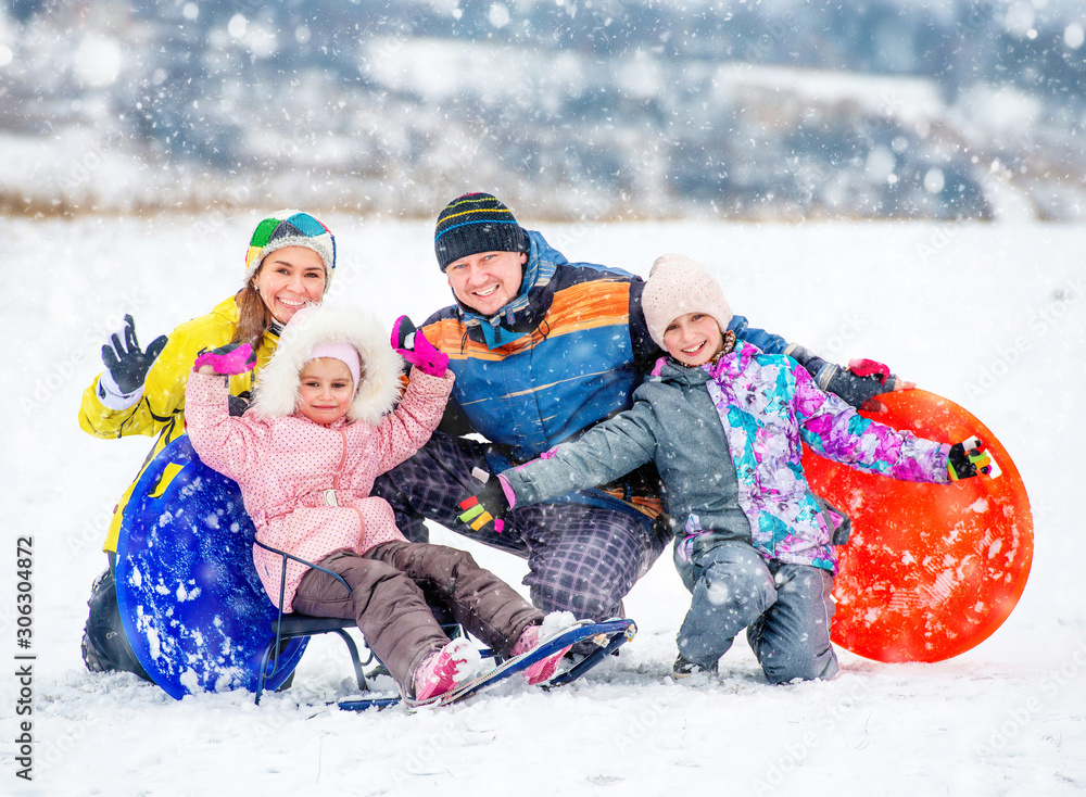 Happy family portrait outdoors at winter time