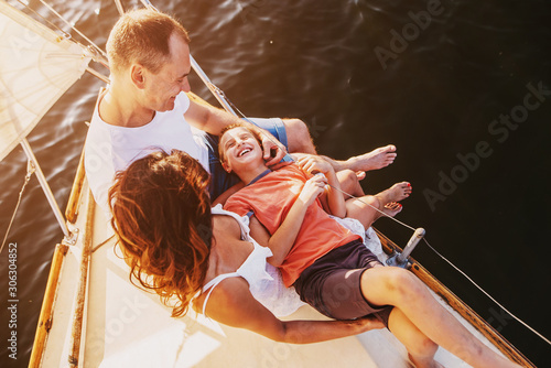 Happy family sailing on a luxury yacht or catamaran boat © VlaDee