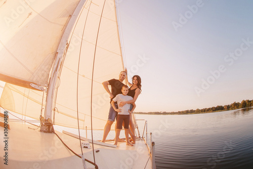 Happy family sailing on a luxury yacht or catamaran boat