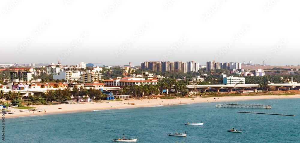 Beautiful Aerial photo of coastline of a developed coastal city which is economically developed and naturally rich. The beach side with boats is perfect place for the residents for hangout and fishing