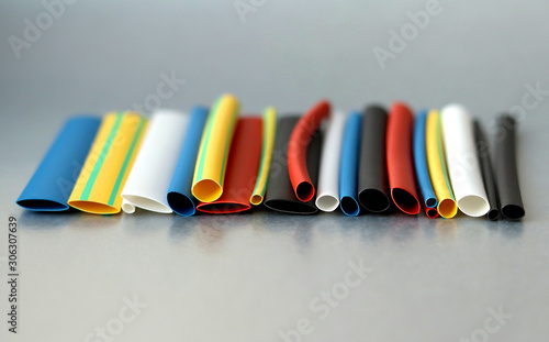 A set of colored heat shrink tubing on the gray background. Selective focus. Electrical equipment. 