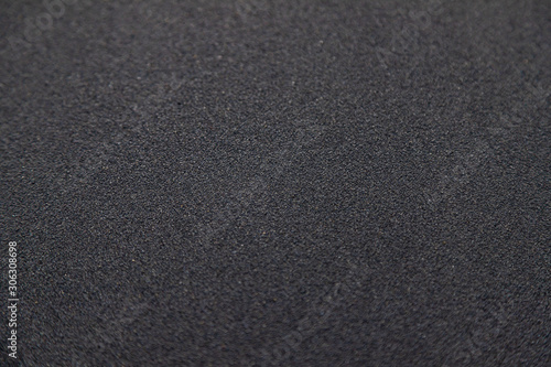 Soft smooth Black sand texture on the beach with little pebble spread around for background