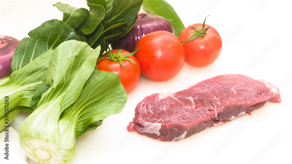 Raw beef with fresh vegetable shed pats Raw beef with fresh vegetable shed pats
