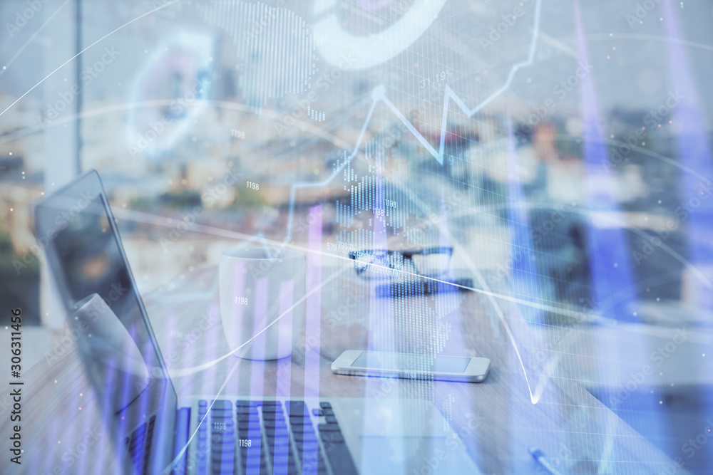 Forex Chart hologram on table with computer background. Double exposure. Concept of financial markets. Forex Chart hologram on table with computer background. Double exposure. Concept of financial markets.
