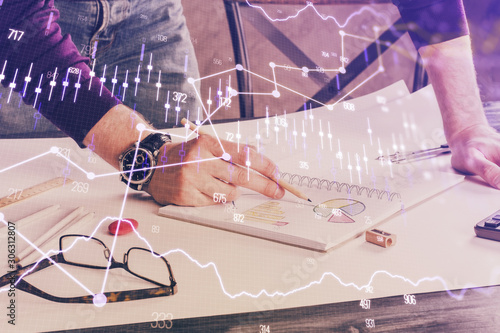 Financial trading chart double exposure with man desktop background.