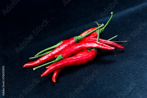 Red pepper isolated on black background.