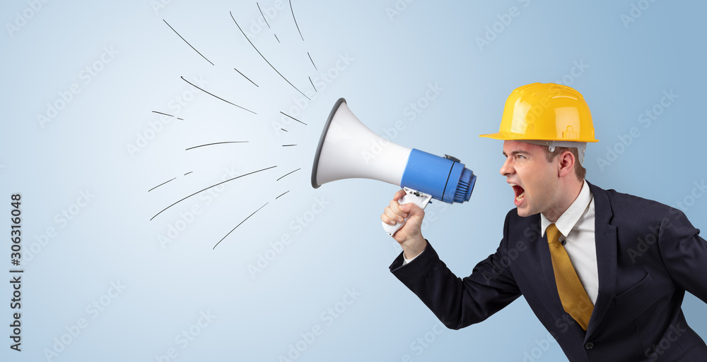 Young architect constructor yelling with megaphone and copyspace Young architect constructor yelling with megaphone and copyspace