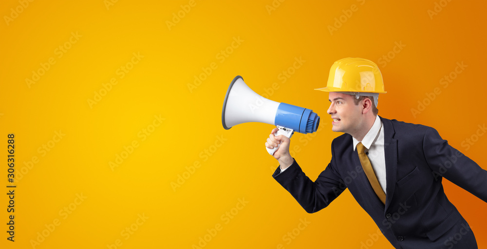 Young architect constructor yelling with megaphone and copyspace Young architect constructor yelling with megaphone and copyspace