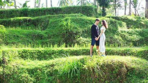 Laos, Asia, Romance on the rice fields. young couple flirting in the tropical agricultural land. Parallax shot photo