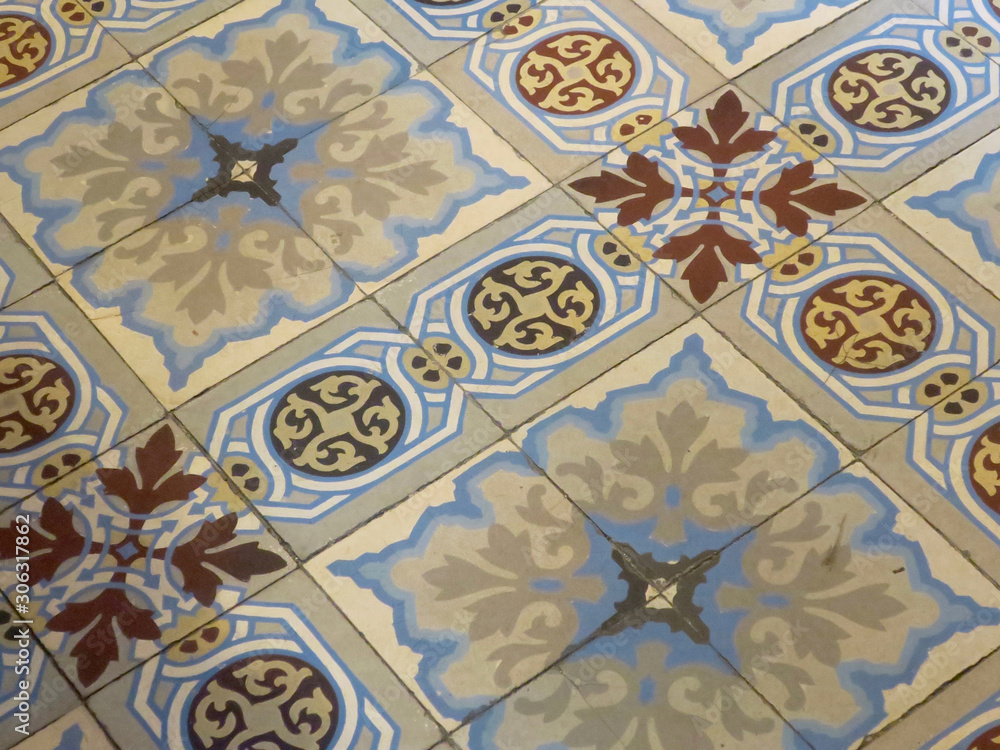 antique tiled floor with a floral pattern in a bookshop in Antwerpen antique tiled floor with a floral pattern in a bookshop in Antwerpen