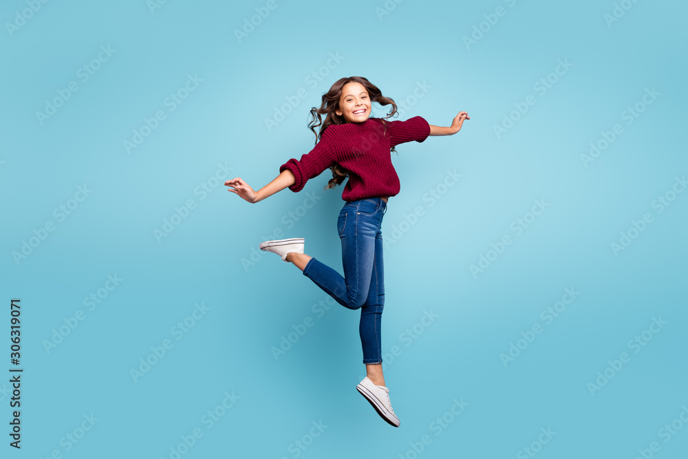 Full length body size side profile photo of cheerful positive smiling toothy beaming girl dancing like ballerina curly wavy jumping isolated vivid blue color background