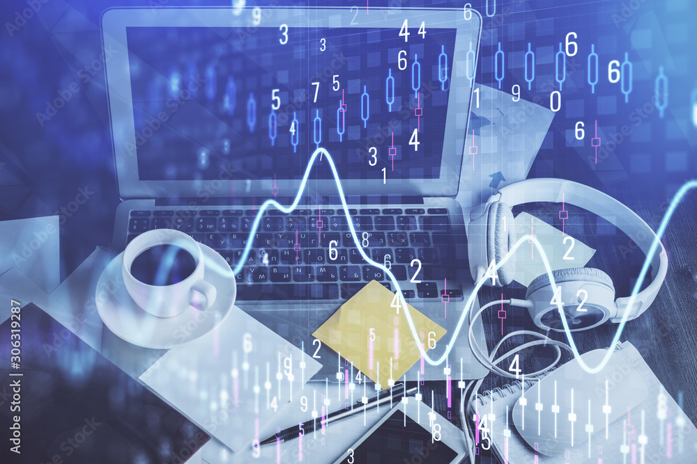 Financial chart drawing and table with computer on background. Double exposure. Concept of international markets. Financial chart drawing and table with computer on background. Double exposure. Concept of international markets.