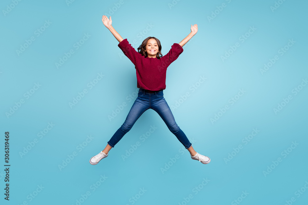 Full length body size photo of cheerful curly positive preteen shaping star with her legs arms jumping free isolated vivid blue color background