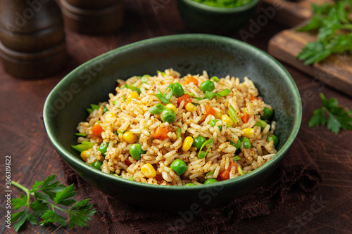 fried rice with vegetables in green bowl