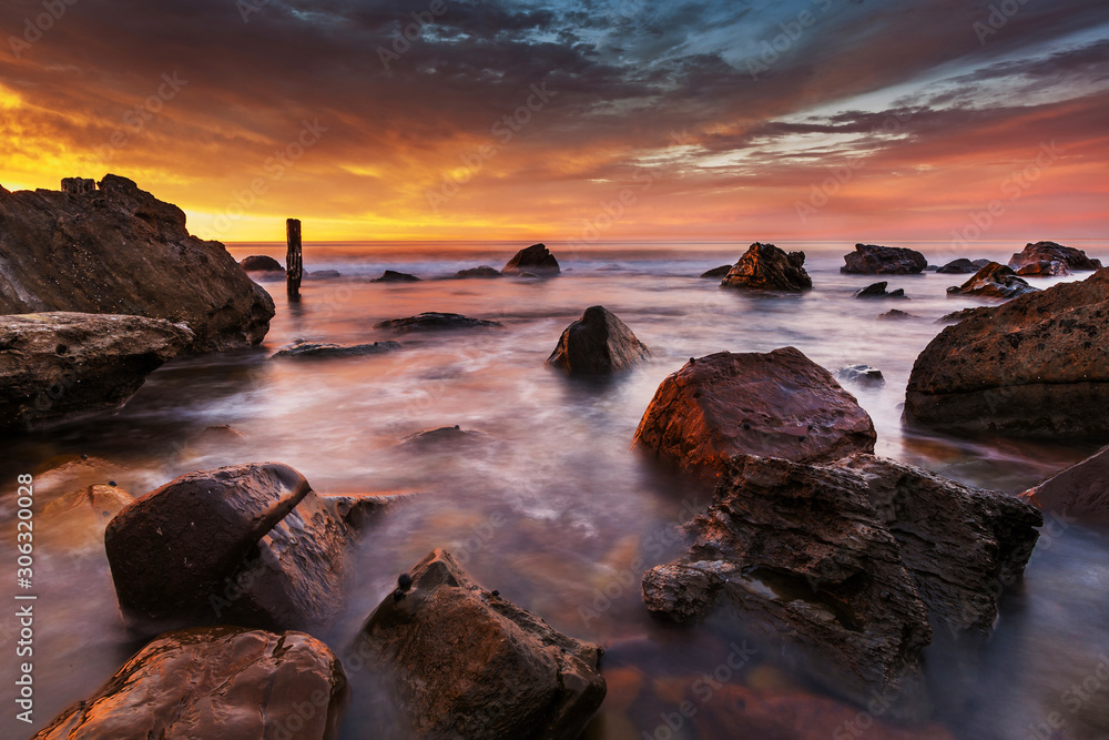 Sunset over a rocky beach on Australia