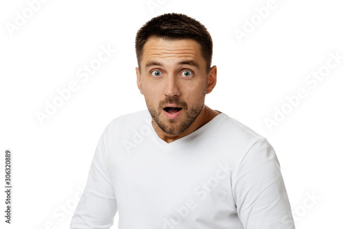 Portrait of young surprised handsome bearded man with shocked facial expression on white background. it's unbelievable