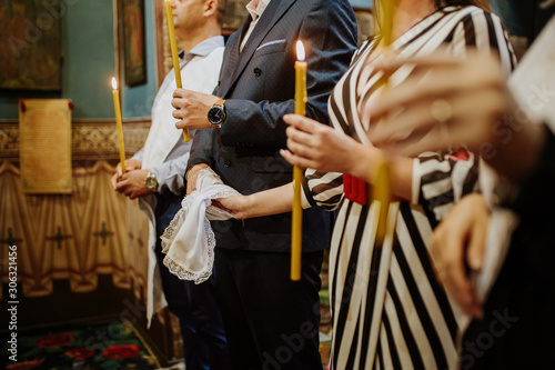 Holding a candle in prayer inside a Christian Orthodox church
