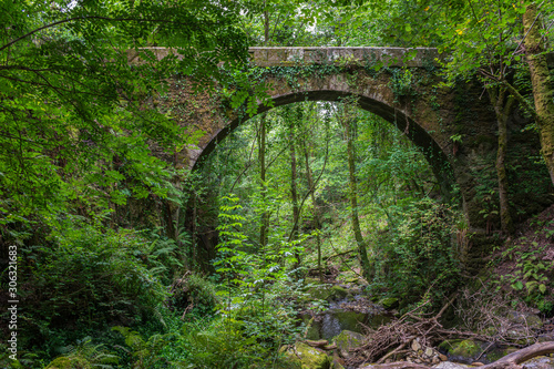arch of the stone bridge over the river Eume in the Fragas do Eume photo