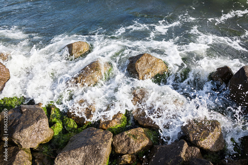Waves breaking onto a stony seashore. © rootstocks