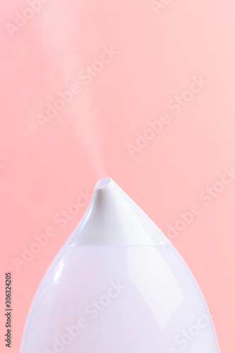 air humidifier on color background .The unique design quickly and effectively eliminates dry air, providing an optimal level of humidity in the room.- Image