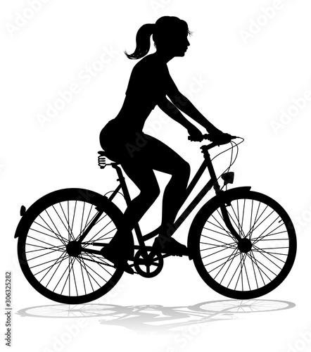 Fototapeta Naklejka Na Ścianę i Meble -  A woman bicycle riding bike cyclist in silhouette