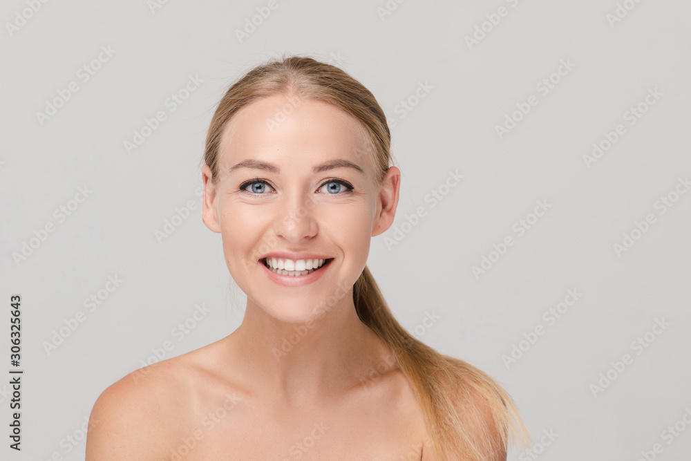 Portrait of adorable young model smiling with open mouth showing teeth isolated at studio white background. Medium close-up happy face of charming fresh naked woman posing looking at camera Portrait of adorable young model smiling with open mouth showing teeth isolated at studio white background. Medium close-up happy face of charming fresh naked woman posing looking at camera
