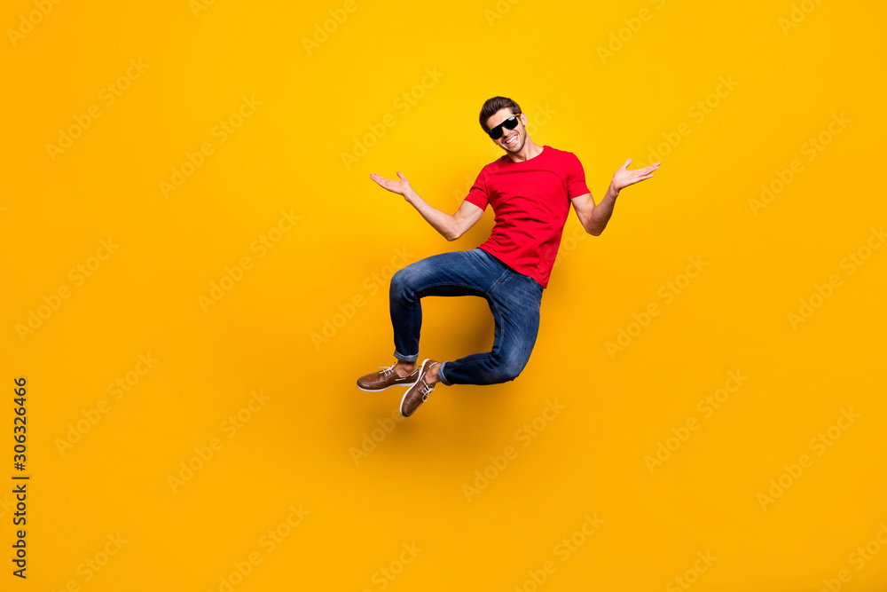 Full length photo of cheerful candid guy enjoy luxury resort spring time recreation jump wear casual style outfit isolated over vibrant color background - obrazy, fototapety, plakaty 