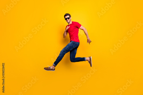 Full body photo of cheerful content guy jump enjoy spring free time holidays wear good looking outfit sneakers isolated over bright color background © deagreez