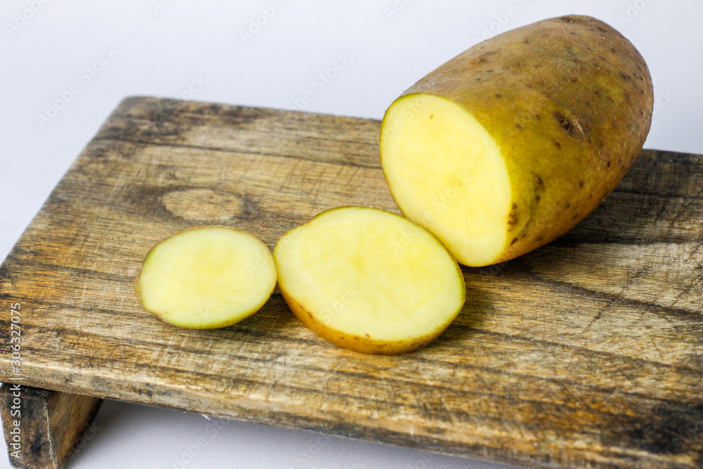 fresh potatoes that have been sliced on the board fresh potatoes that have been sliced on the board