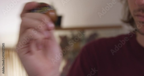 Close Up - A hand painted egg shaker is shaken rhythmically to the beat - shot on RED