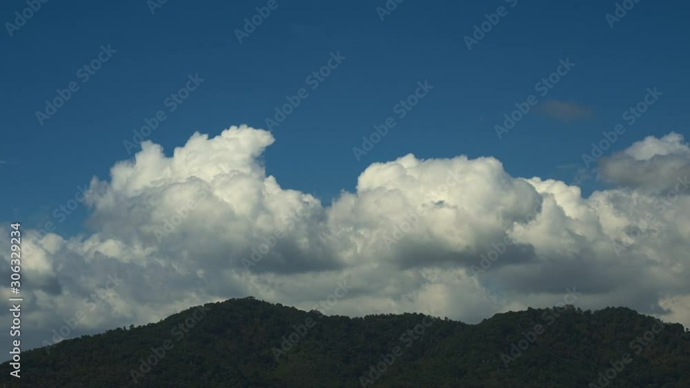 beautiful blue sky with clouds background. Slow motion of moving clouds over the mountains. Thailand, Phuket. 4k beautiful blue sky with clouds background. Slow motion of moving clouds over the mountains. Thailand, Phuket. 4k
