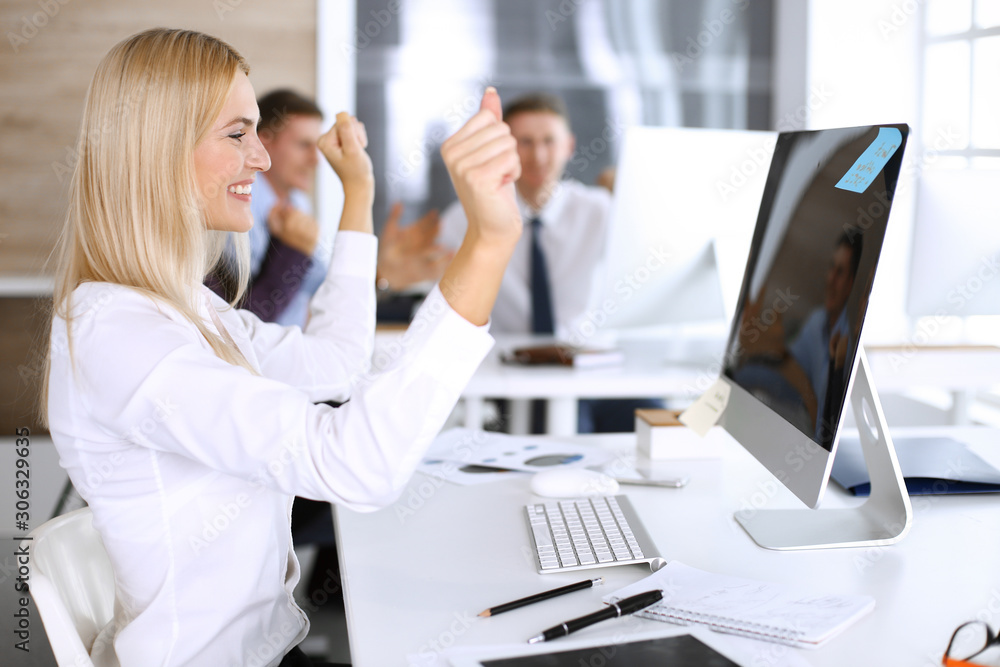 Business woman looks happy and excited at workplace in modern office. Secretary or female lawyer working for pleasure and success Business woman looks happy and excited at workplace in modern office. Secretary or female lawyer working for pleasure and success