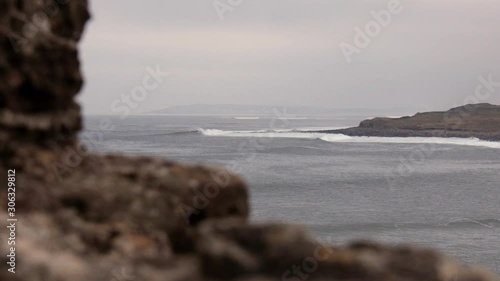 Long atlantic point break waves roll into a bay photo