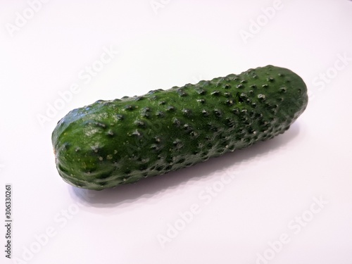 Textured green cucumber on white background