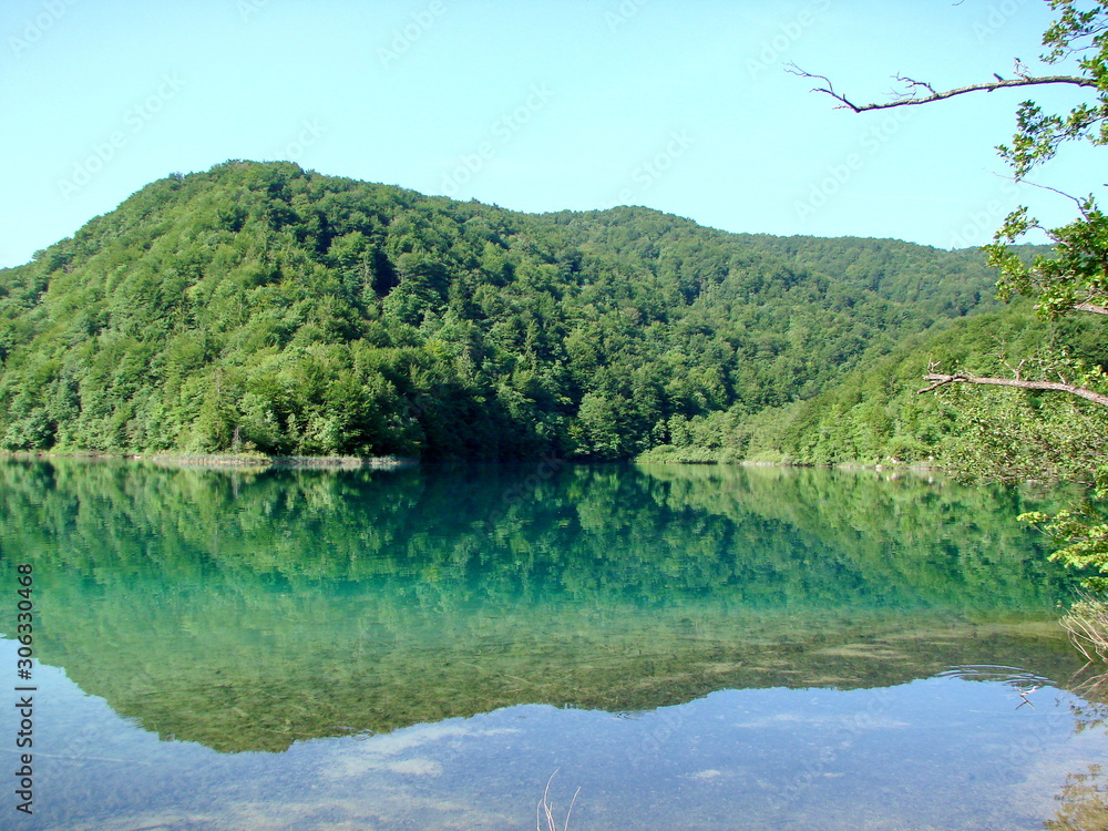 Amazing natural picture of the mirror surface of mountain lakes surrounded by wild, pristine forest. Amazing natural picture of the mirror surface of mountain lakes surrounded by wild, pristine forest.
