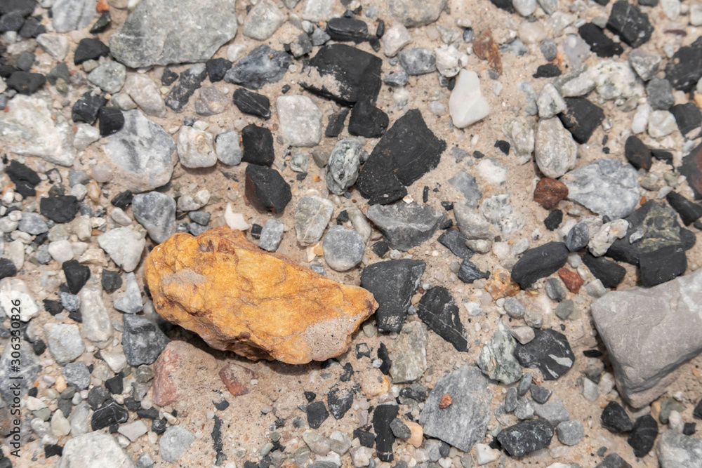 The background of black and orange stones on beach lacked a small, neatly arranged on the ground. The background of black and orange stones on beach lacked a small, neatly arranged on the ground.