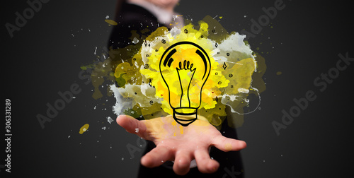 Photos Elegant hand holding lighting bulb in his hand, new idea concept