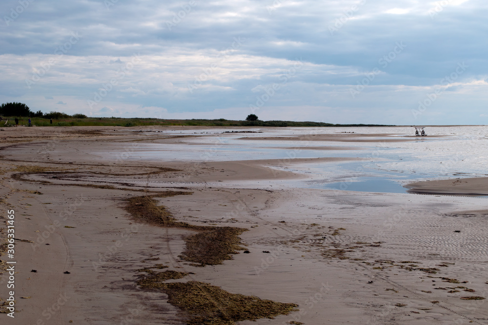 Ainazi Latvia, view along beach with seaweed at low tide Ainazi Latvia, view along beach with seaweed at low tide