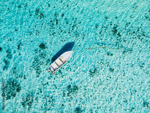 White boat in ocean in paradise island. Aerial view.