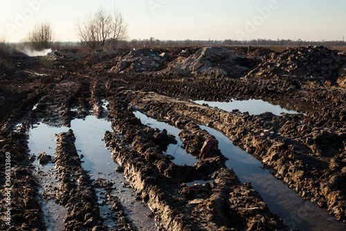 Fotografie Mud and puddles on the dirt road
