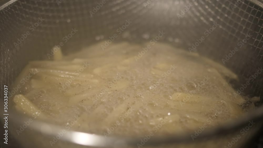 French fries potato chips frying in oil 4k French fries potato chips frying in oil 4k