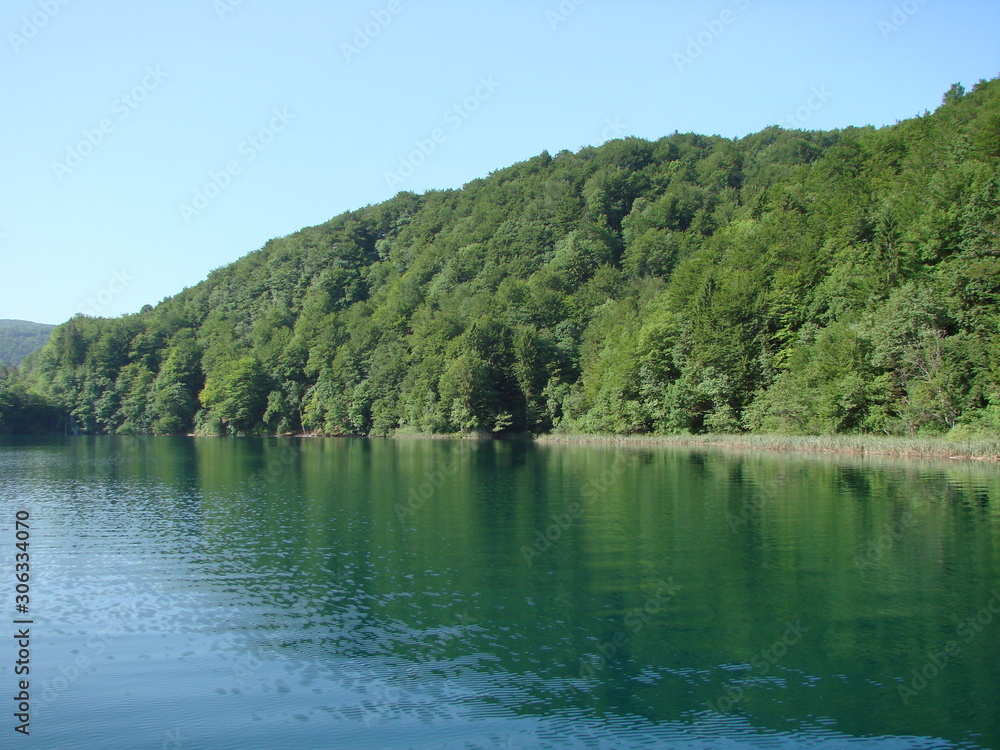 Amazing natural picture of the mirror surface of mountain lakes surrounded by wild, pristine forest.