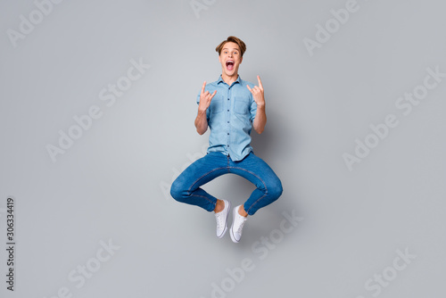Fototapeta Naklejka Na Ścianę i Meble -  Full size photo of crazy funky hipster guy visit pank music concert feel rejoice jump show horned signs wear casual style outfit isolated over grey color background