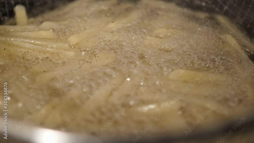 French fries potato chips frying in oil 4k French fries potato chips frying in oil 4k