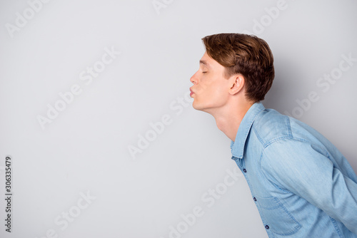 Profile side photo of dreamy cupid guy have date with his girlfriend send air kiss wear stylish clothing isolated over grey color background