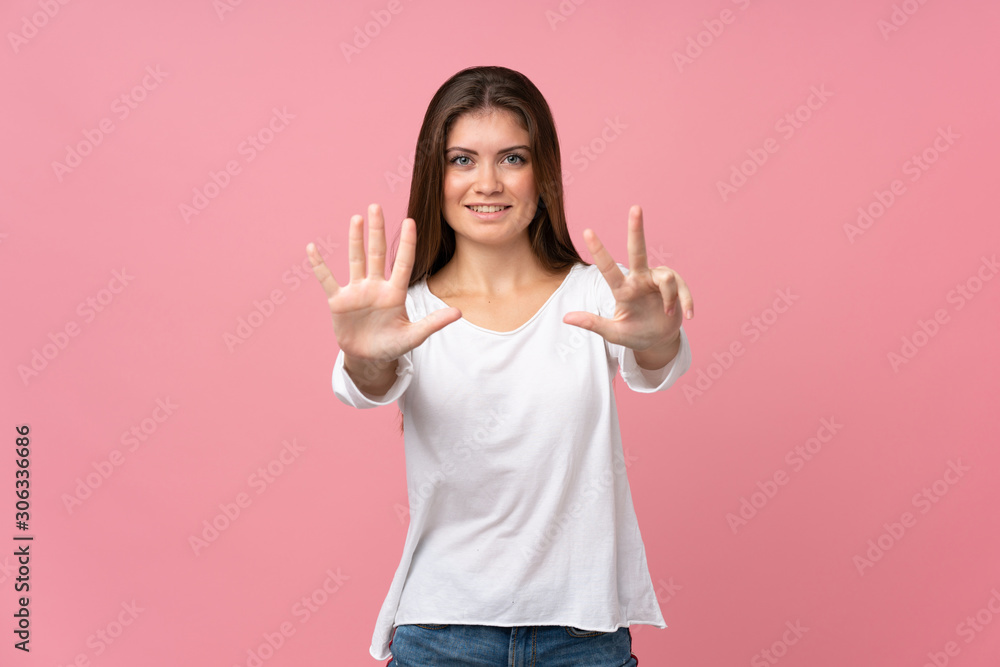 Young woman over isolated pink background counting eight with fingers Young woman over isolated pink background counting eight with fingers