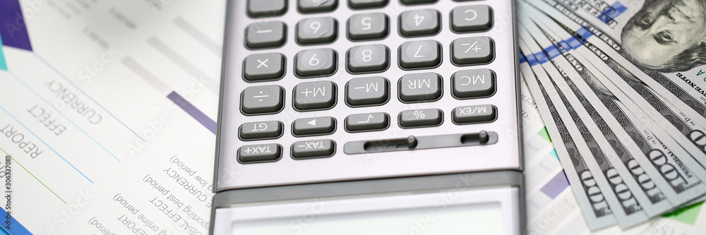 Silver calculator with gray keyboard is lying Silver calculator with gray keyboard is lying