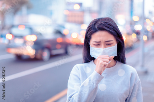 young woman wear mask in the city during Smog day