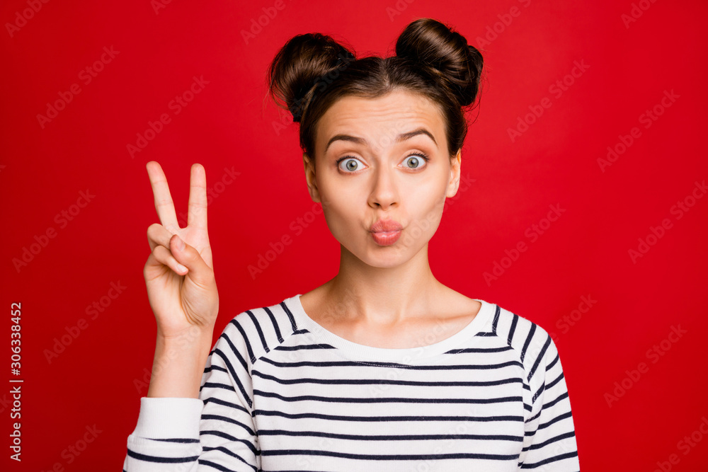 Portrait of sweet girlish girl have weekends free time make v-signs send air kiss wear casual style clothing white isolated over red color background Portrait of sweet girlish girl have weekends free time make v-signs send air kiss wear casual style clothing white isolated over red color background