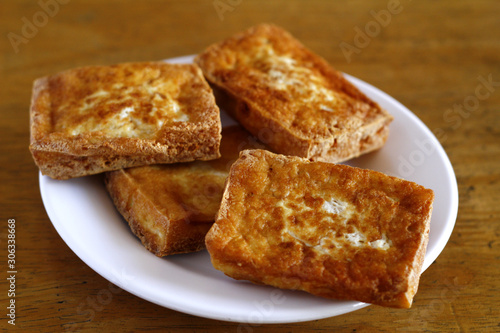 Stack of freshly fried tokwa or tofu © junpinzon